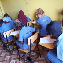 KCT students seated at desks writing during a training session